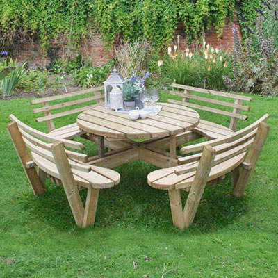 a circular wooden picnic table with seating